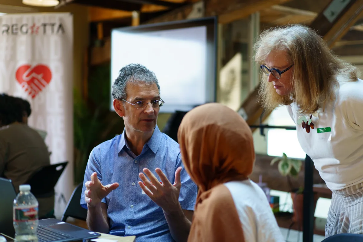 Mentors and participants discussing a project at Seattle 2026